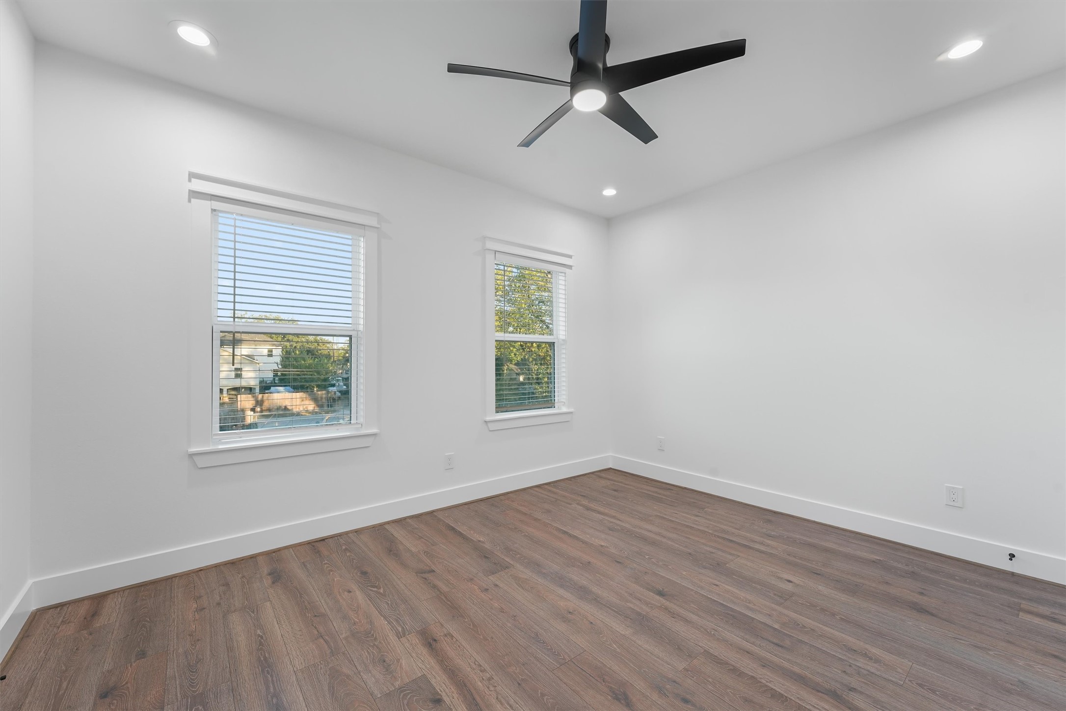 4208 Castor Street, Unit A Houston, TX 77022 - Photo 19 of 23 an empty room with wooden floor ceiling fan and windows