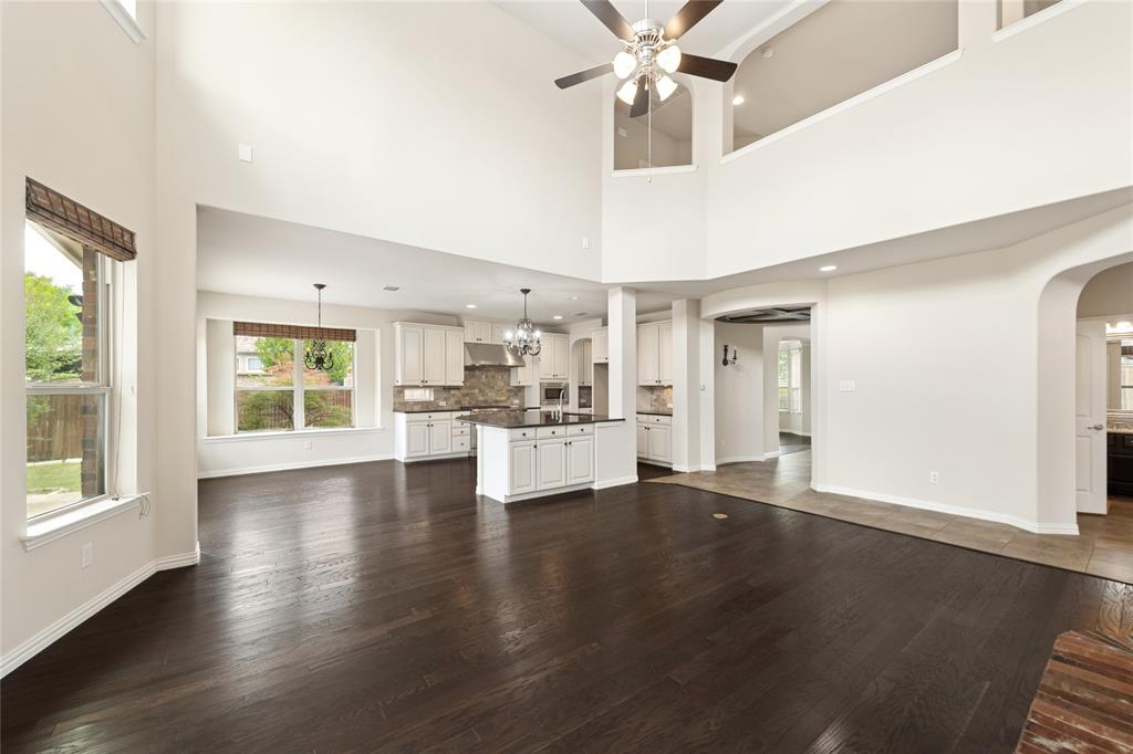 12571 Valley Spring Drive Frisco, TX 75035 - Photo 13 of 39 a view of an empty room with wooden floor and a window
