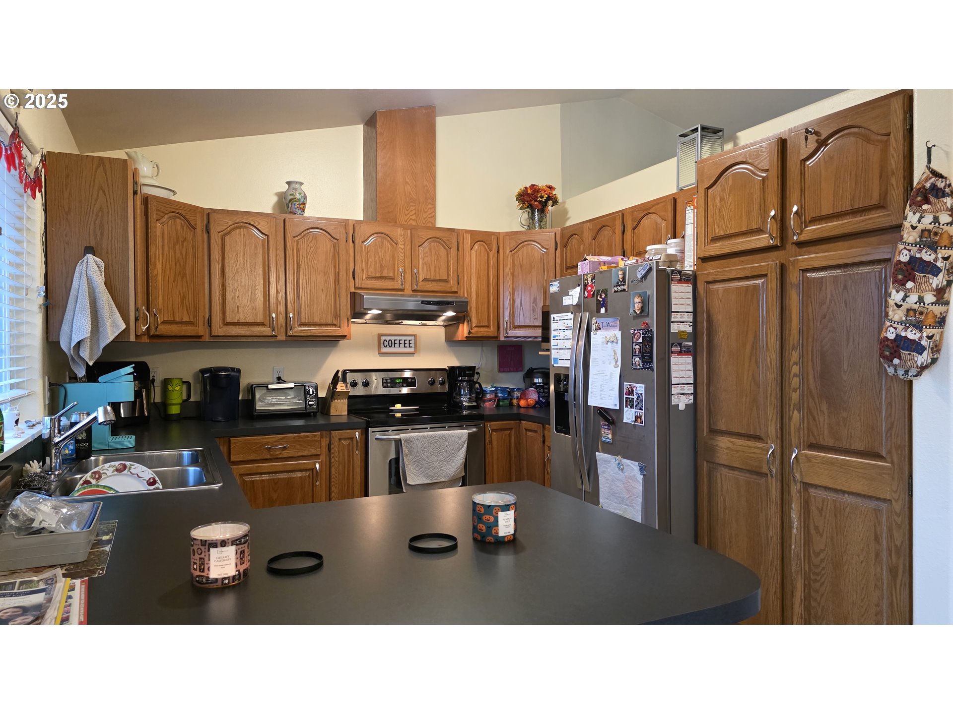 934 South 46th Street Springfield, OR 97478 - Photo 11 of 37 a kitchen with stainless steel appliances kitchen island granite countertop a refrigerator and cabinets