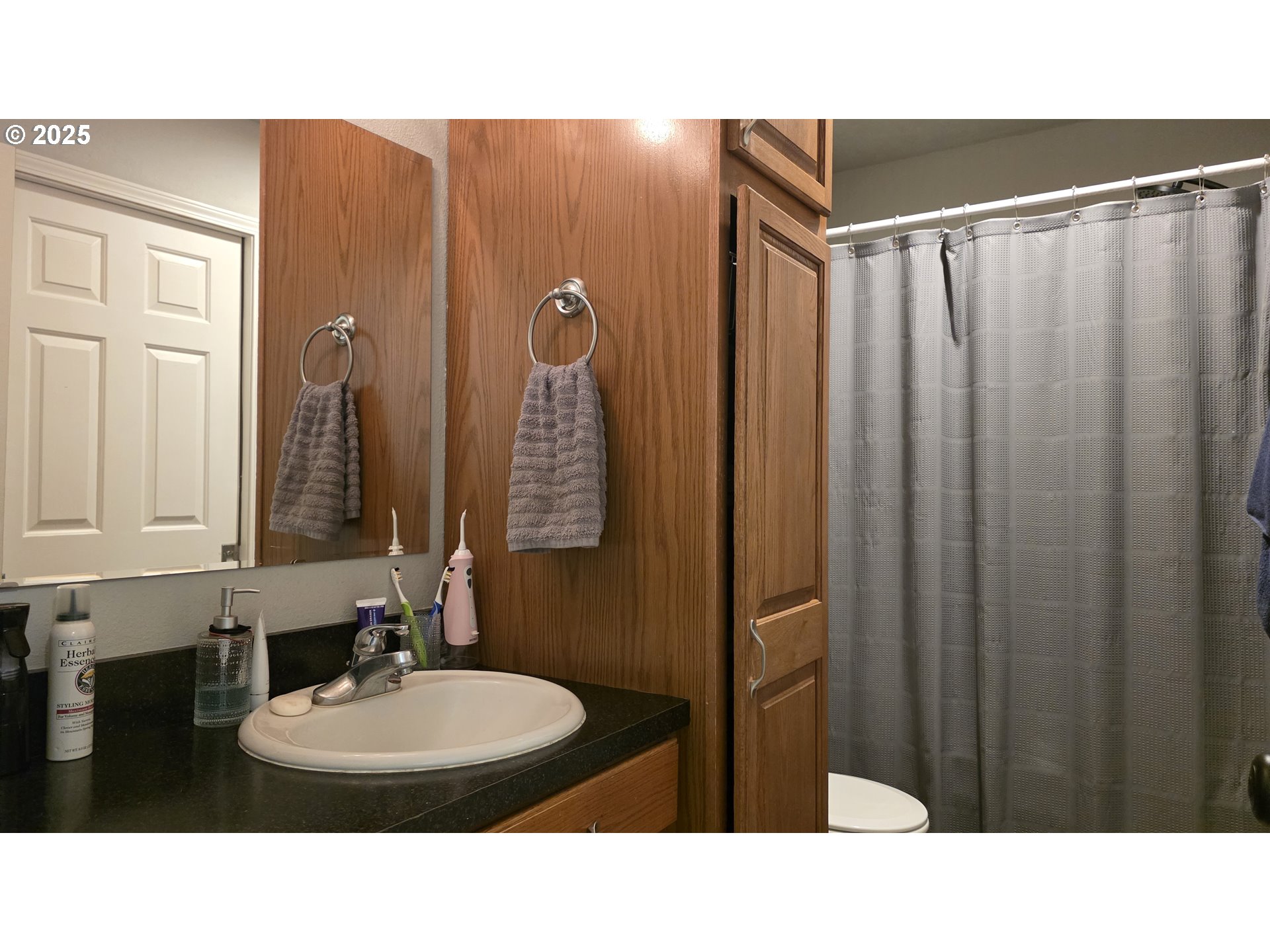 934 South 46th Street Springfield, OR 97478 - Photo 19 of 37 a bathroom with a sink a mirror and a shower
