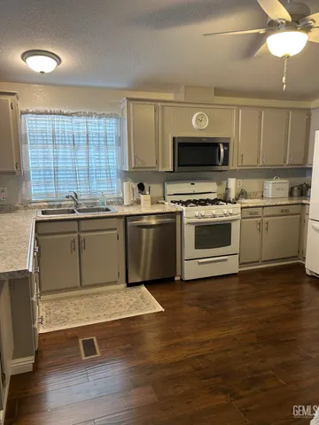 a kitchen with a sink cabinets and window