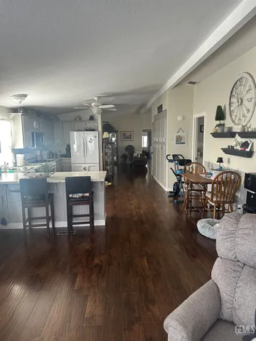 a living room with lots of furniture and kitchen view