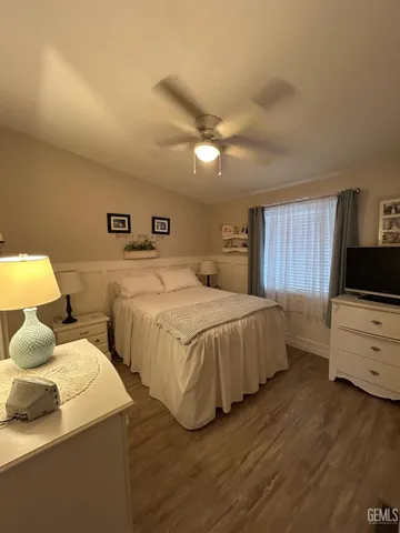 a bedroom with two beds and a flat screen tv
