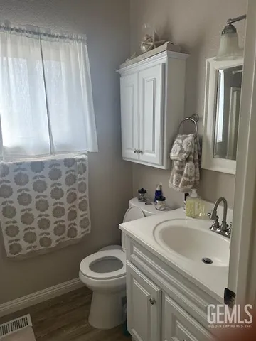 a bathroom with a sink a toilet and a mirror