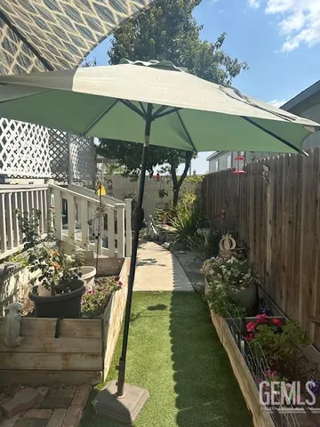 a view of a chairs and table under an umbrella in patio