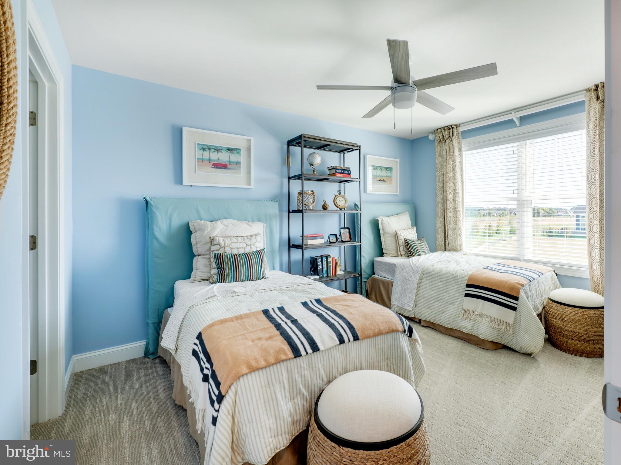 19499 Safflower Way Lewes, DE 19958 - Photo 10 of 24 a bedroom with a bed and a couch
