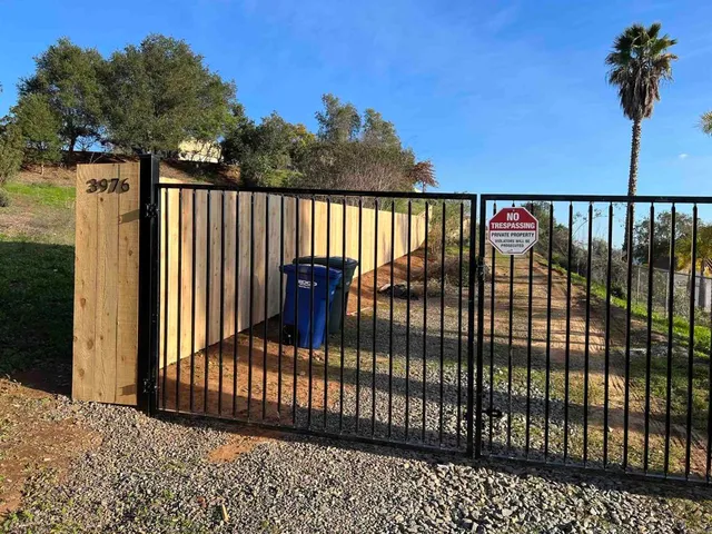 a view of a lush green hillside and houses