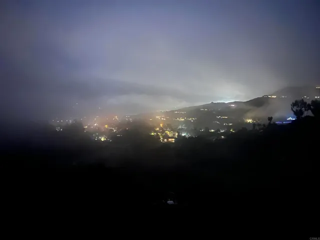 an aerial view of mountain with trees around