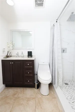 a bathroom with a sink a toilet and a mirror