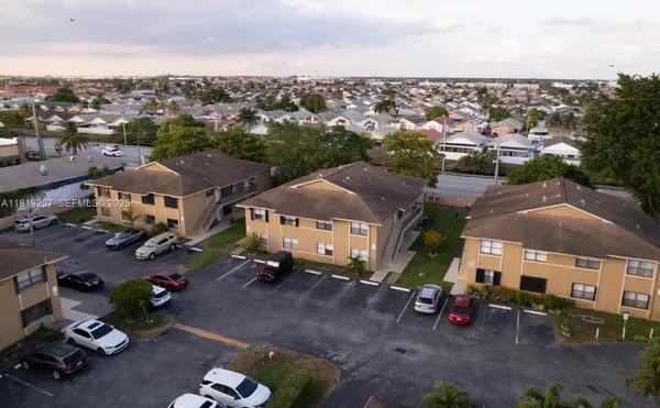 an aerial view of multiple houses with a yard