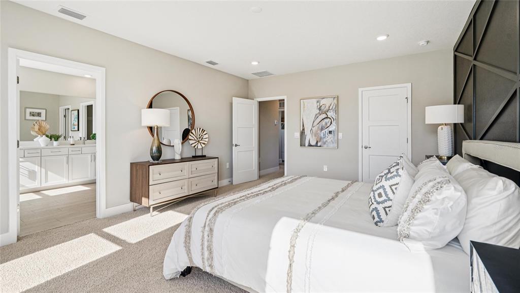 1732 Northwest 127th Street Gainesville, FL 32606 - Photo 23 of 30 a bedroom with a bed and a large mirror