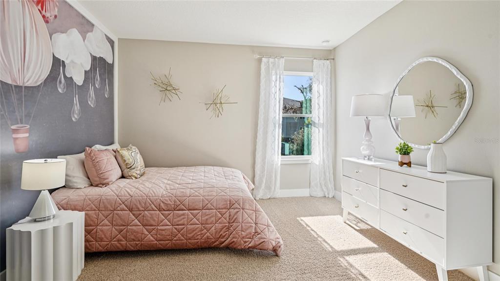 1732 Northwest 127th Street Gainesville, FL 32606 - Photo 27 of 30 a bedroom with a bed mirror and a window