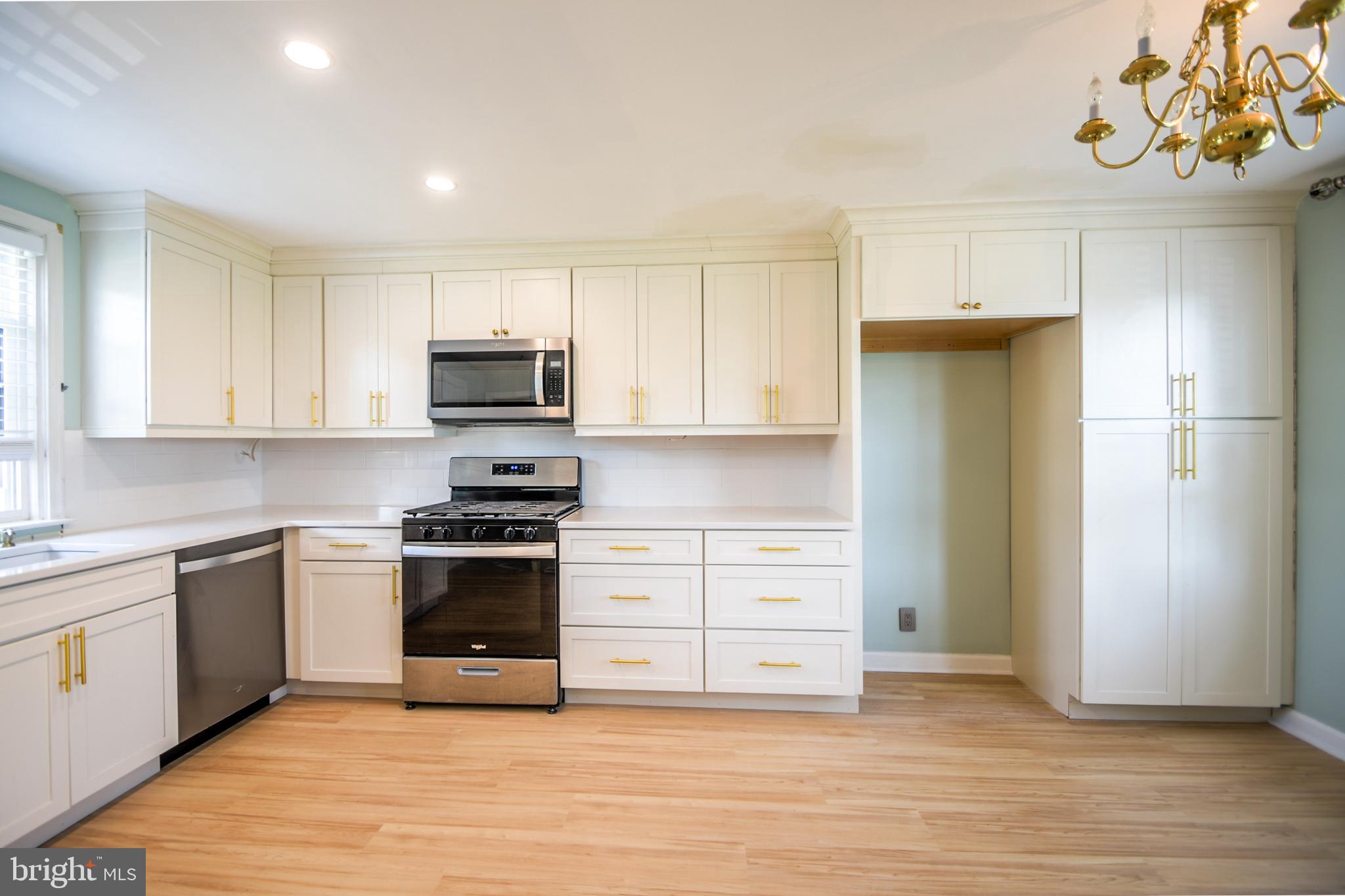 616 Wayne Avenue Springfield, PA 19064 - Photo 12 of 33 a kitchen with a sink stainless steel appliances and cabinets