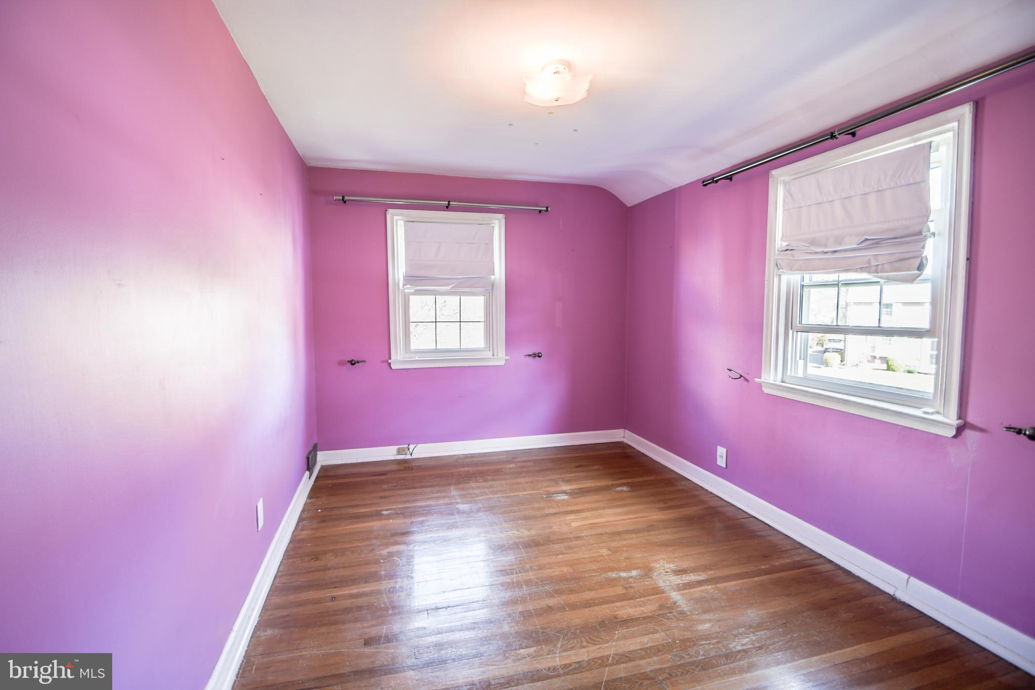 616 Wayne Avenue Springfield, PA 19064 - Photo 19 of 33 a view of an empty room with wooden floor and a window