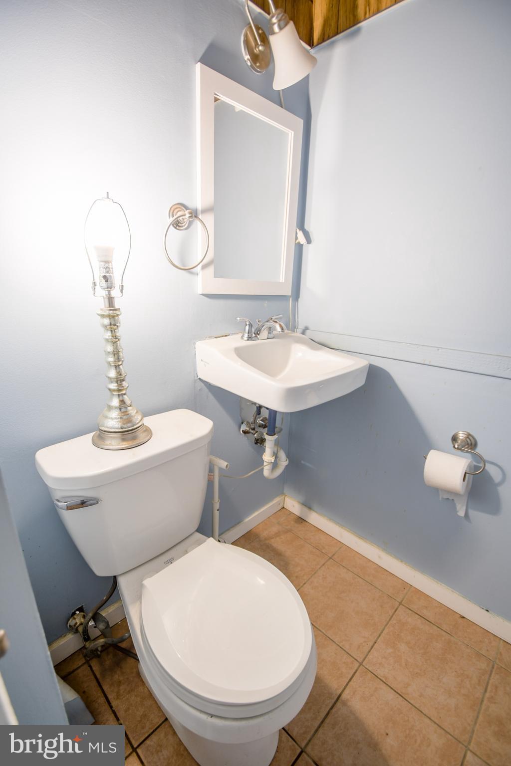 616 Wayne Avenue Springfield, PA 19064 - Photo 28 of 33 a bathroom with a sink mirror and toilet