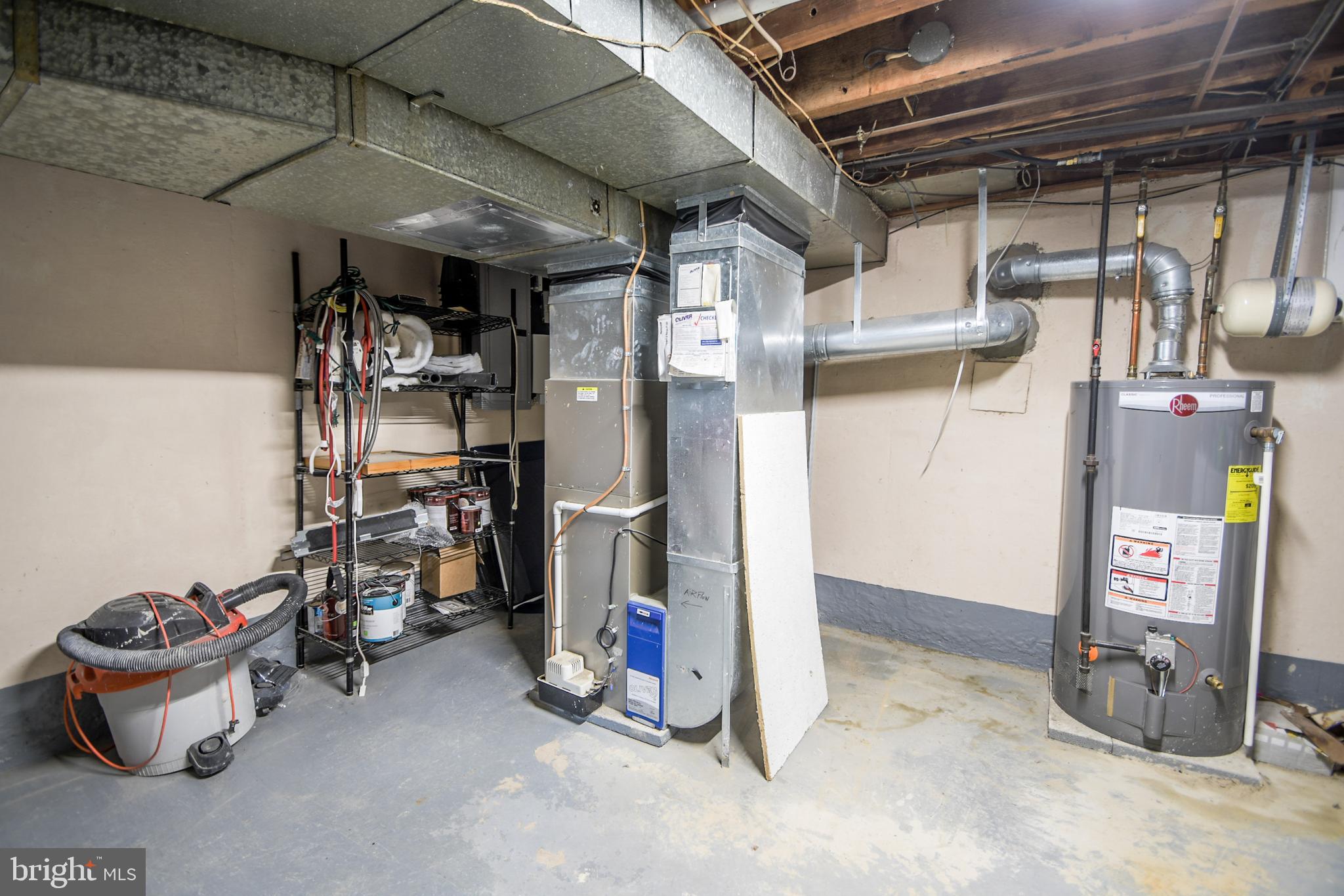 616 Wayne Avenue Springfield, PA 19064 - Photo 30 of 33 a view of a storage room with water heater and racks