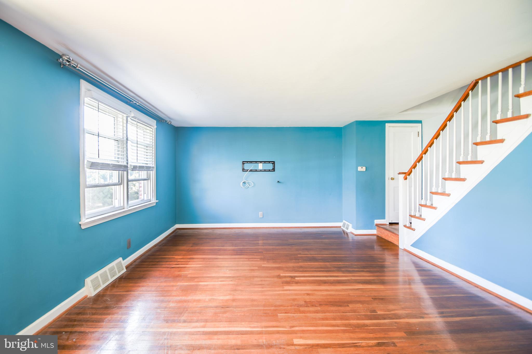 616 Wayne Avenue Springfield, PA 19064 - Photo 9 of 33 a view of an empty room with wooden floor and a window