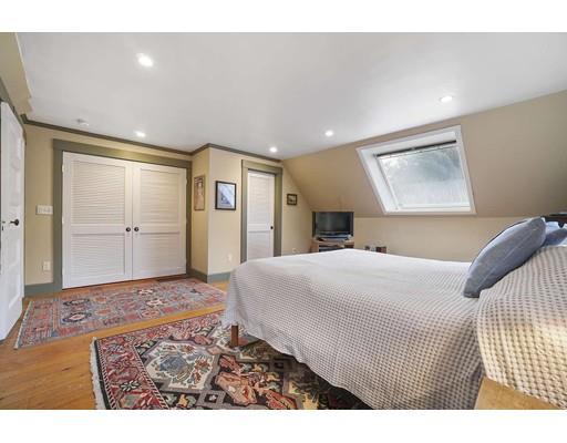 213 Brattle Street Cambridge, MA 02138 - Photo 26 of 30 a spacious bedroom with a bed and a walk in closet