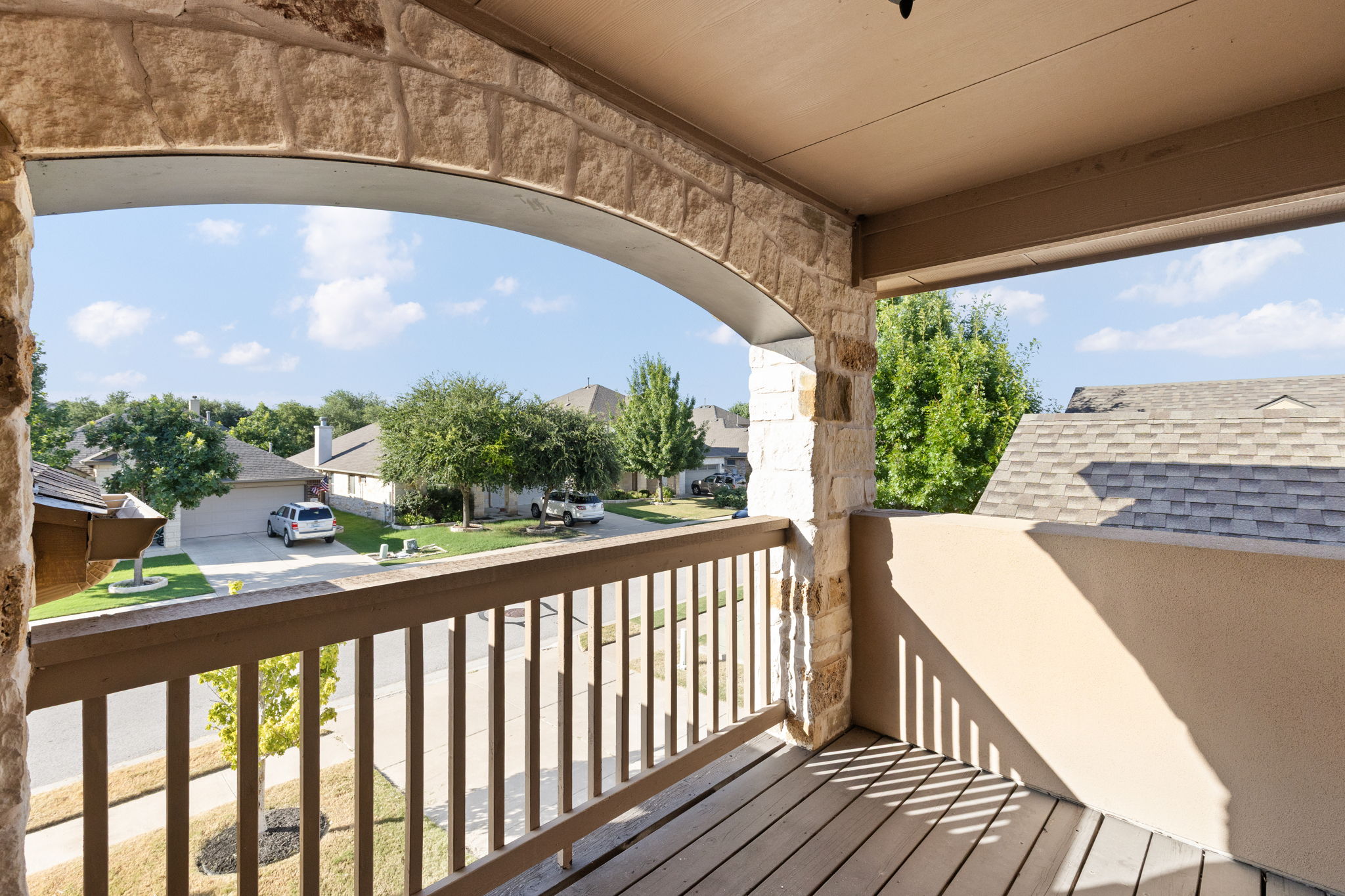 2400 Leonards Pass Leander, TX 78641 - Photo 25 of 40 An inviting balcony with an arched stone entrance offers a pleasant view of the quiet neighborhood street.