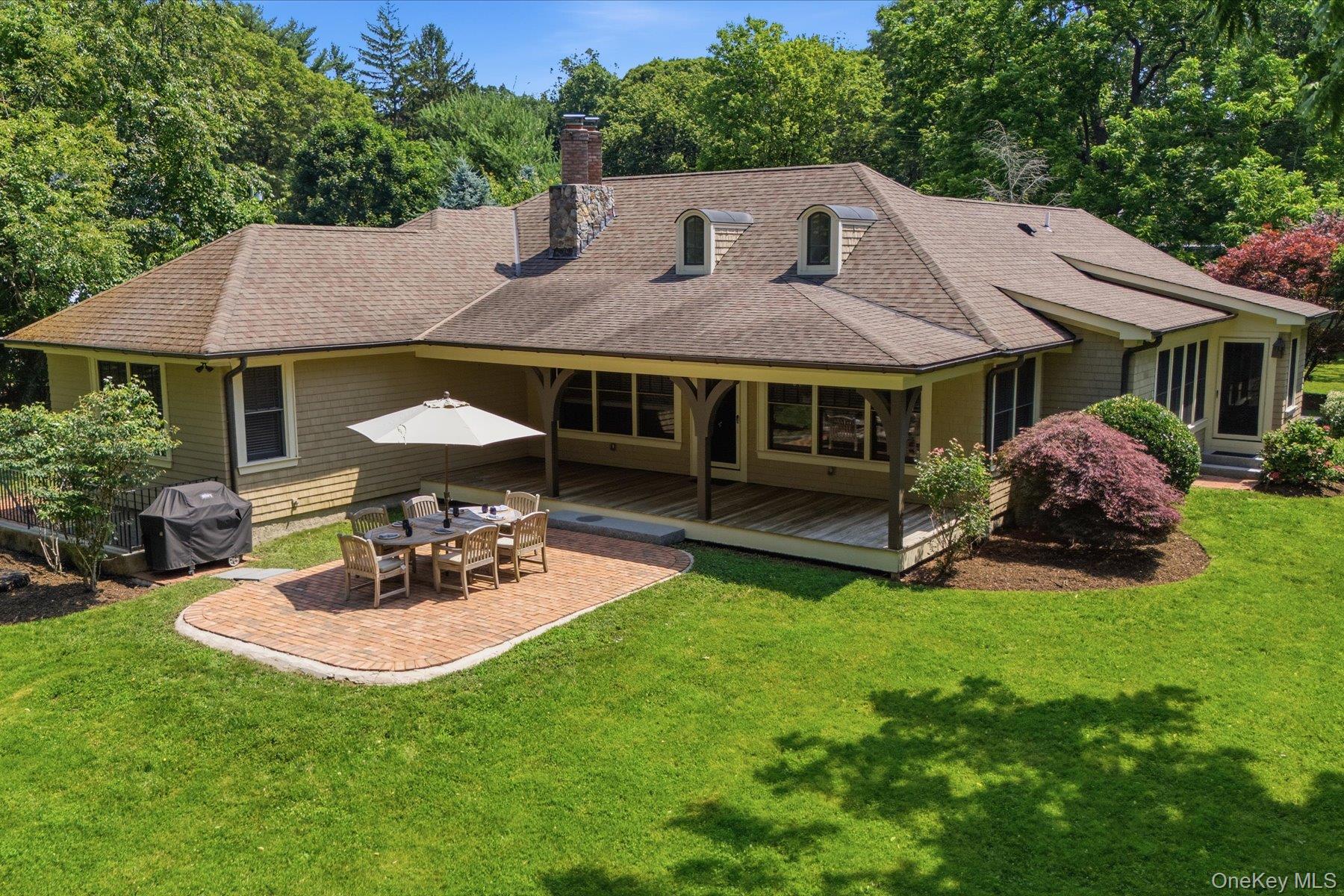 134 Sandy Hollow Road Northport, NY 11768 - Photo 24 of 28 Covered rear porch overlooking the expansive backyard and stone patio.
