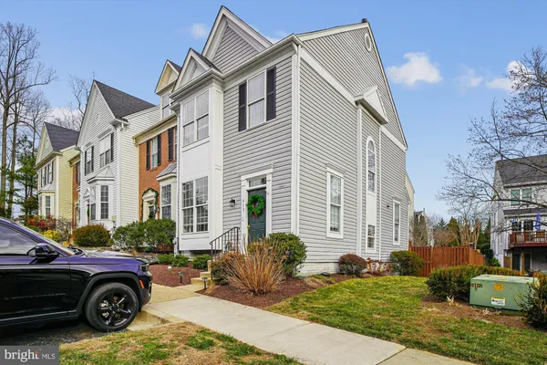 a car parked in front of a white house