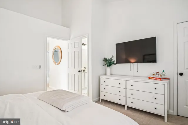 a bedroom with furniture and painting on the wall