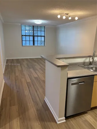 a view of a kitchen with a sink and dishwasher