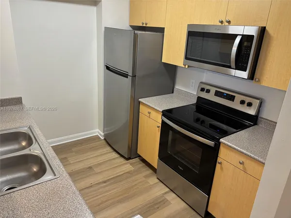 a kitchen with a refrigerator stove and microwave