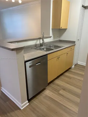 a kitchen with stainless steel appliances granite countertop a sink and a cabinets