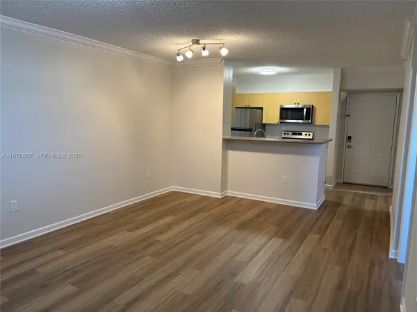 a view of kitchen with wooden floor and electronic appliances