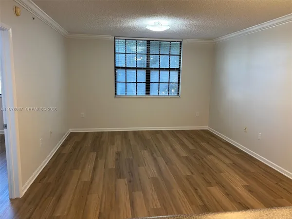 a view of a room with wooden floor and window
