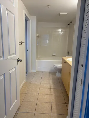 a bathroom with a sink a toilet and a shower