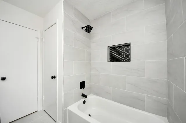 a bathroom with a bathtub and shower