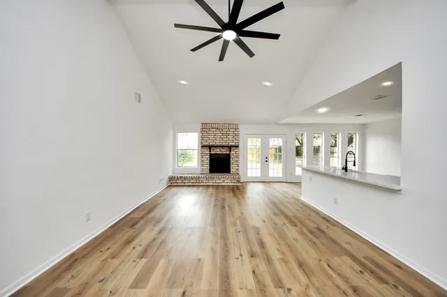 wooden floor in an empty room with a fireplace