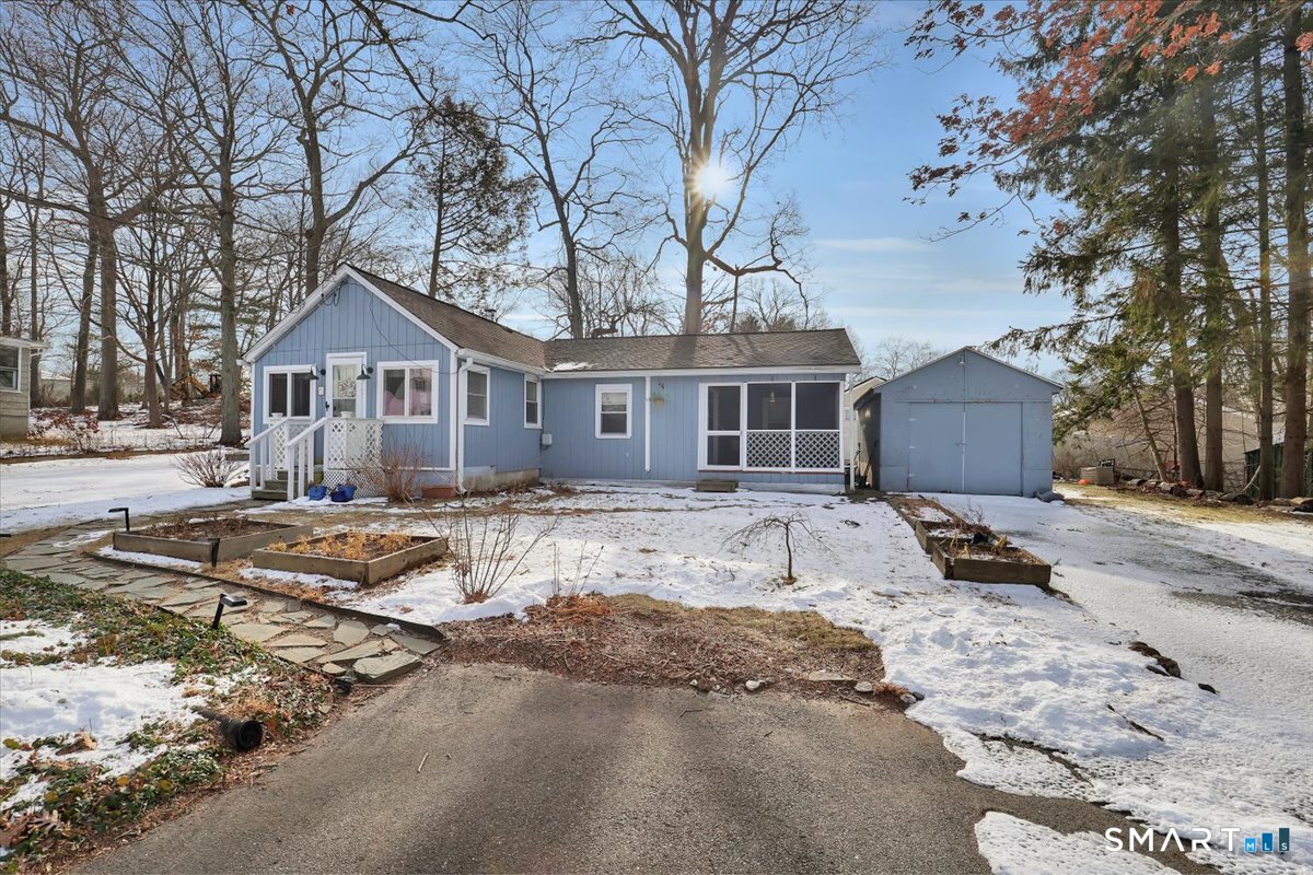 a front view of a house with a yard covered in snow