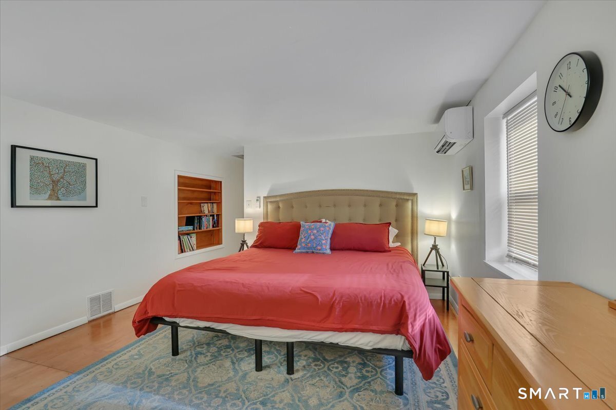 5 Seminole Trail East Hampton, CT 06424 - Photo 11 of 22 a bedroom with a bed a chair and a potted plant on table