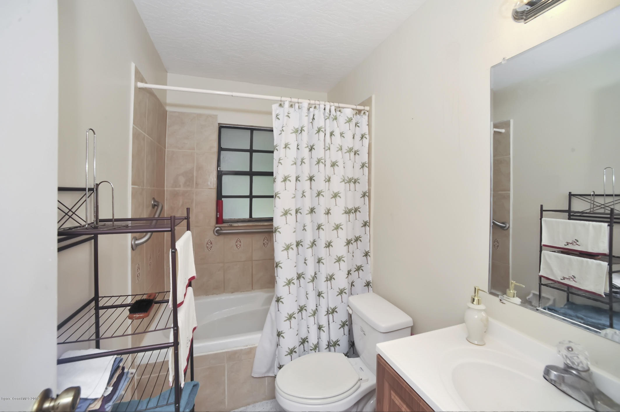 461 Wildmer Road Southwest Palm Bay, FL 32908 - Photo 13 of 15 a bathroom with a sink toilet and shower