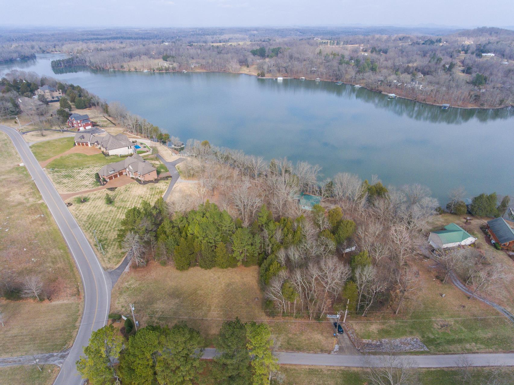 an aerial view of a house with a lake view