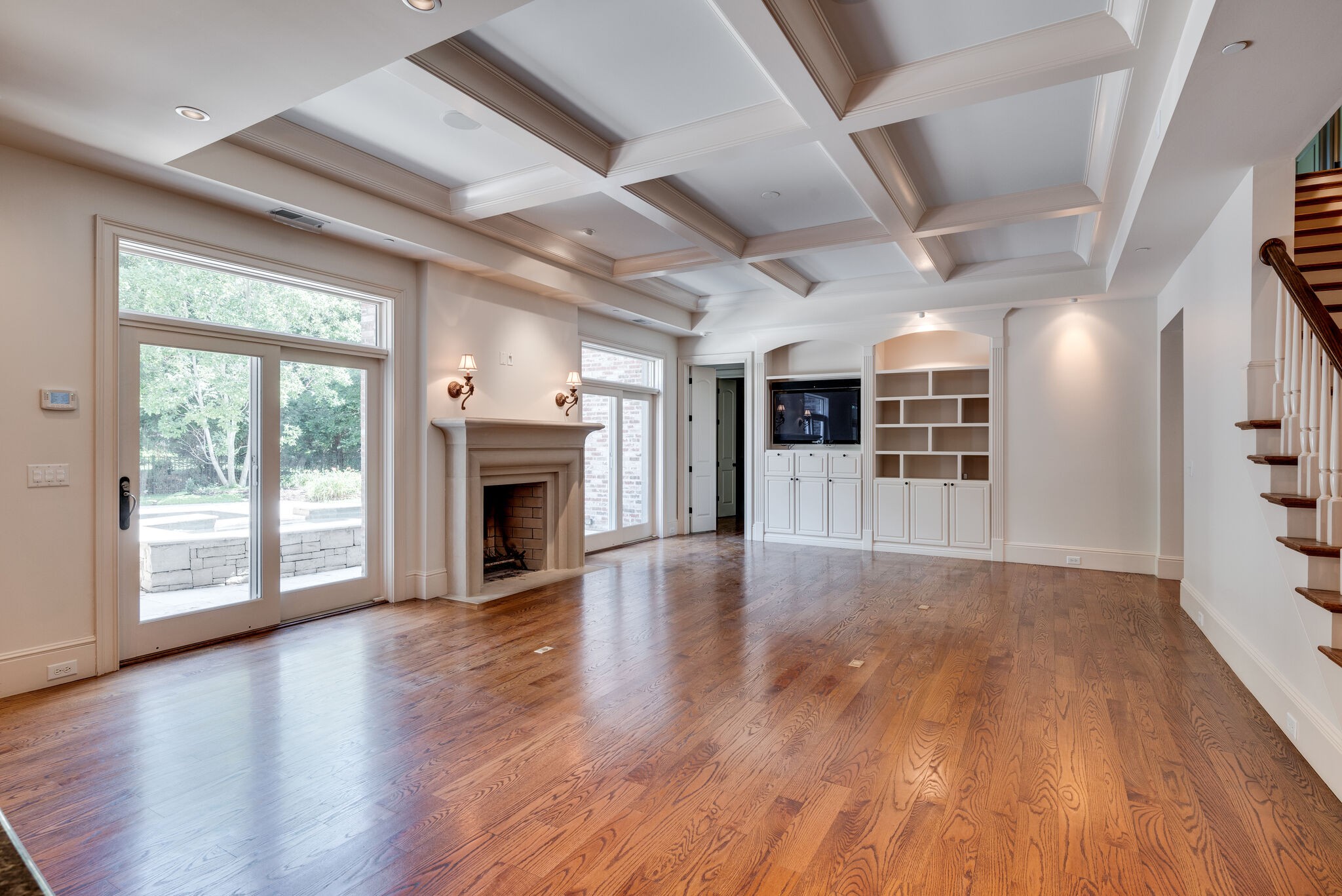 3816 Trimble Road Nashville, TN 37215 - Photo 3 of 26 an empty room with wooden floor fireplace and windows