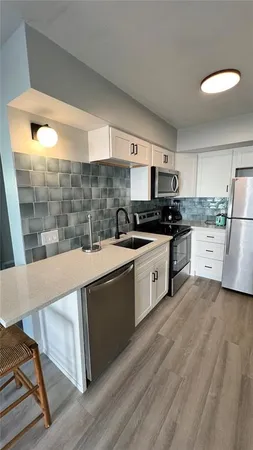 a kitchen with a sink and a stove top oven