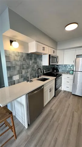 a kitchen with a sink and a stove top oven