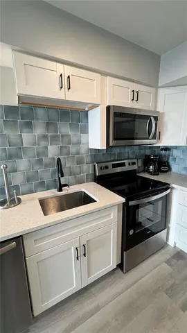 a kitchen with a stove and a microwave