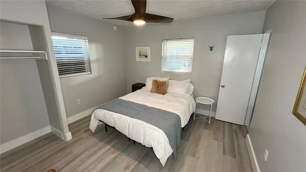 a bedroom with a bed and wooden floor