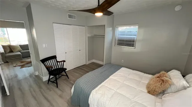 a bedroom with a bed chair and window