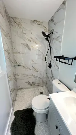 a bathroom with a toilet and a shower