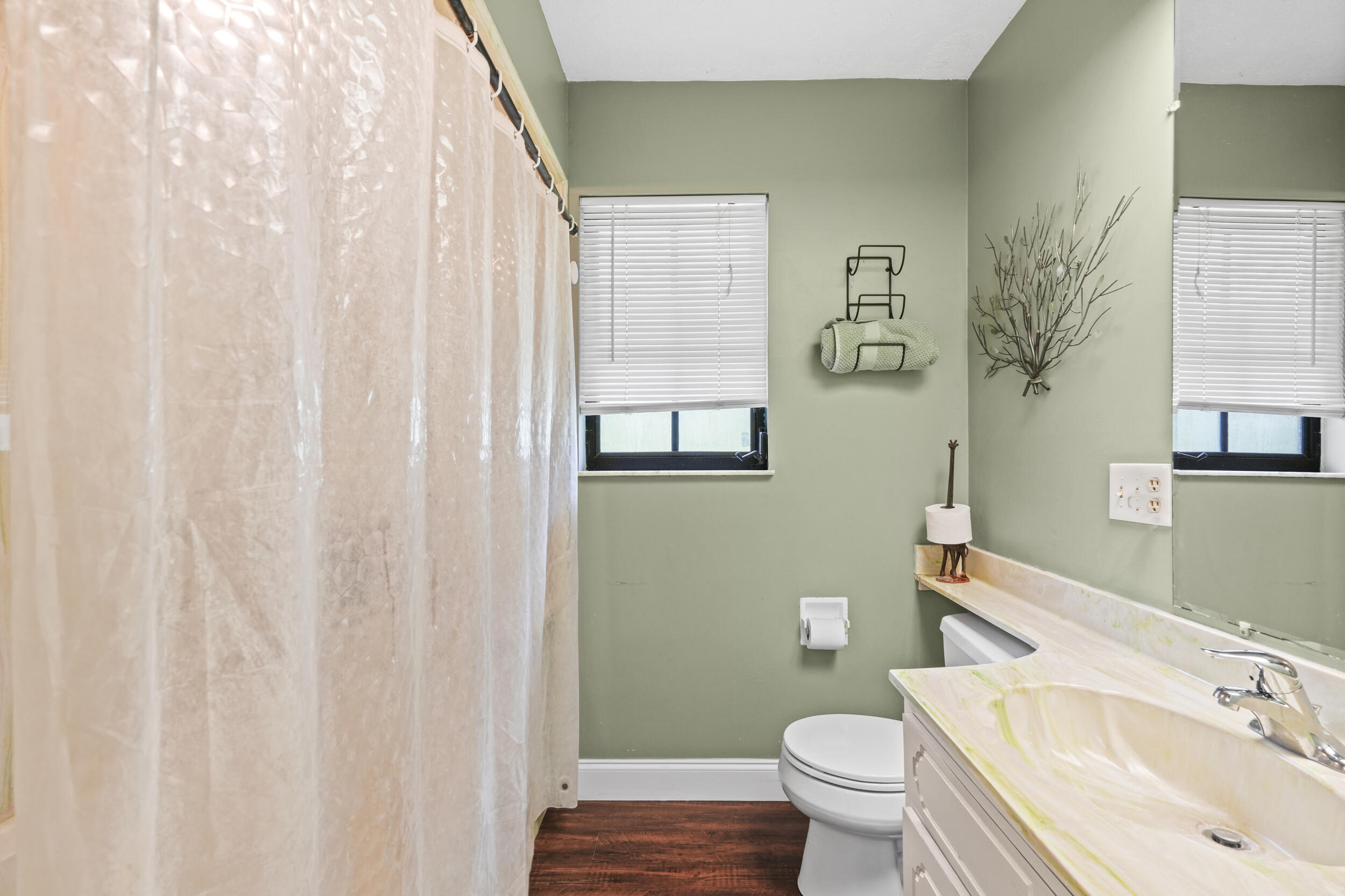 4170 McCarty Road Fort Pierce, FL 34945 - Photo 35 of 57 a bathroom with a sink toilet and a mirror
