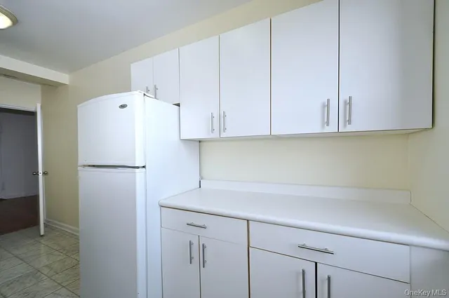 a white refrigerator freezer sitting inside of a kitchen