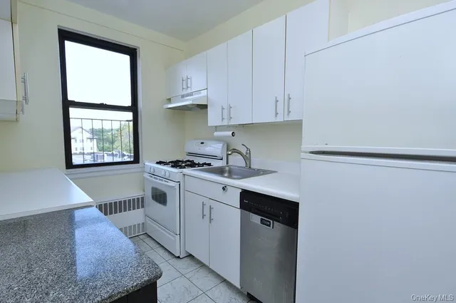 a kitchen with a sink cabinets and window