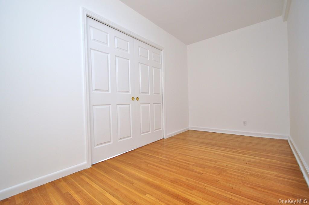 142 Garth Road, Unit 4A Scarsdale, NY 10583 - Photo 16 of 44 a view of empty room with wooden floor