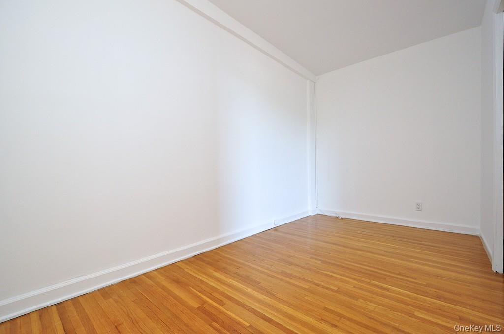 142 Garth Road, Unit 4A Scarsdale, NY 10583 - Photo 19 of 44 a view of empty room with wooden floor
